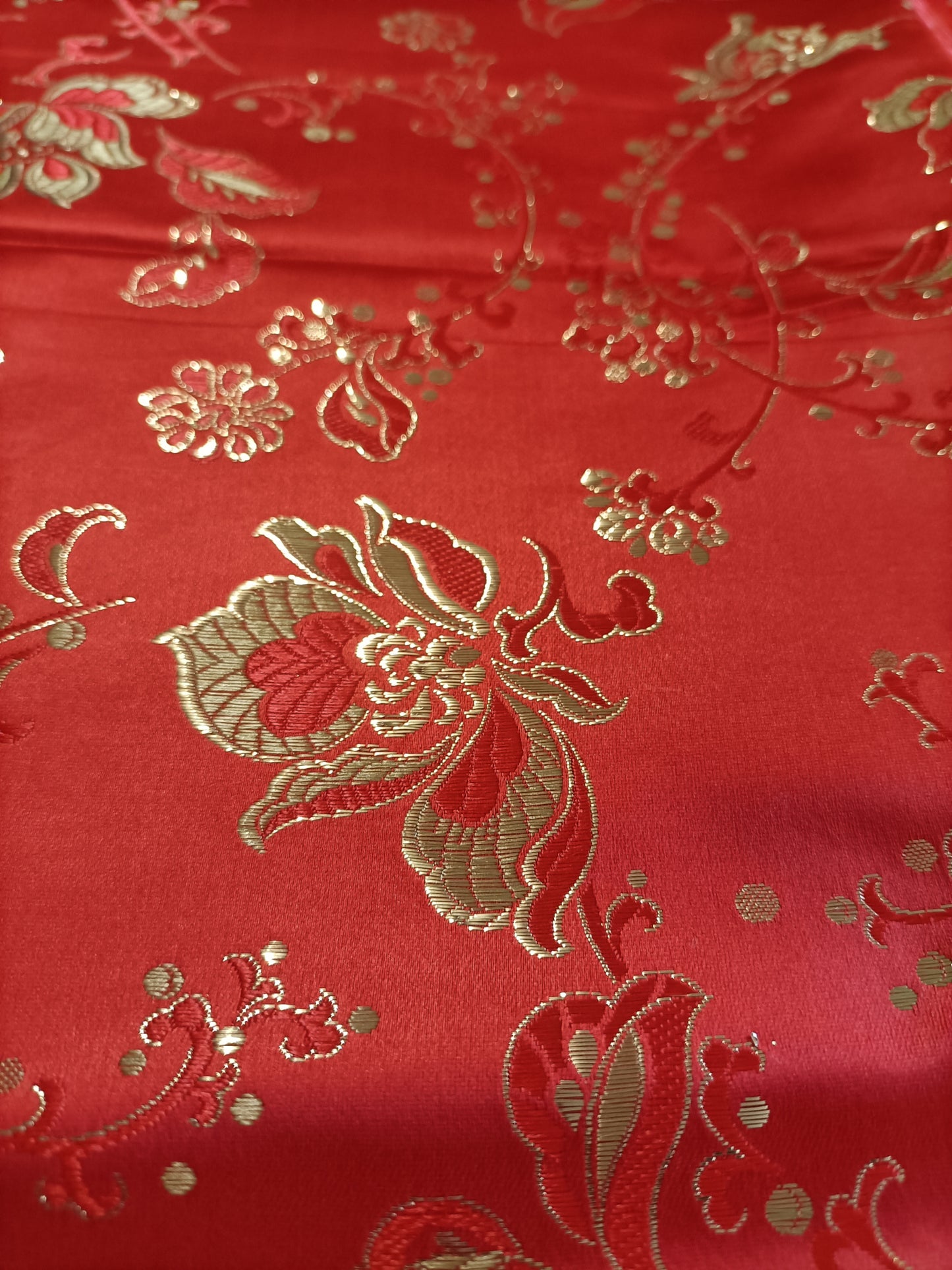Closeup of pattern on red satin brocade
