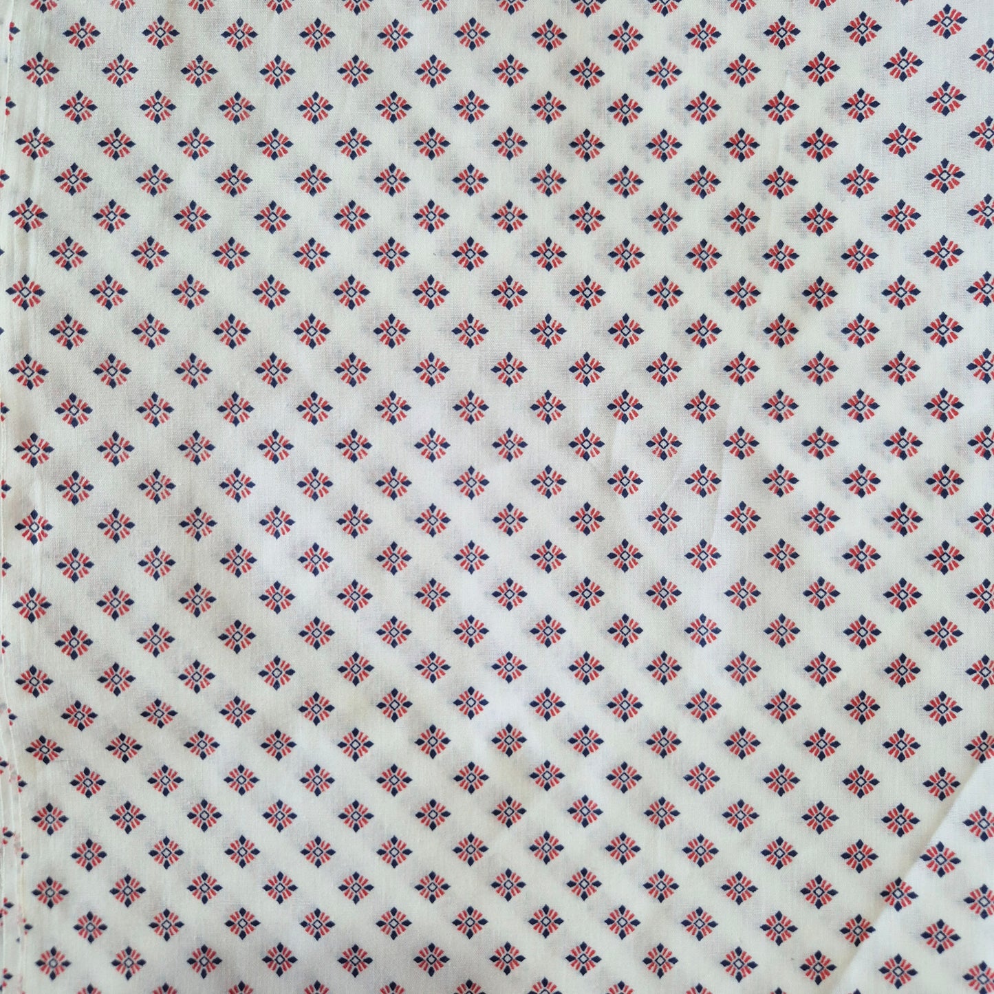 Patterned fabric with small geometric design on a white background