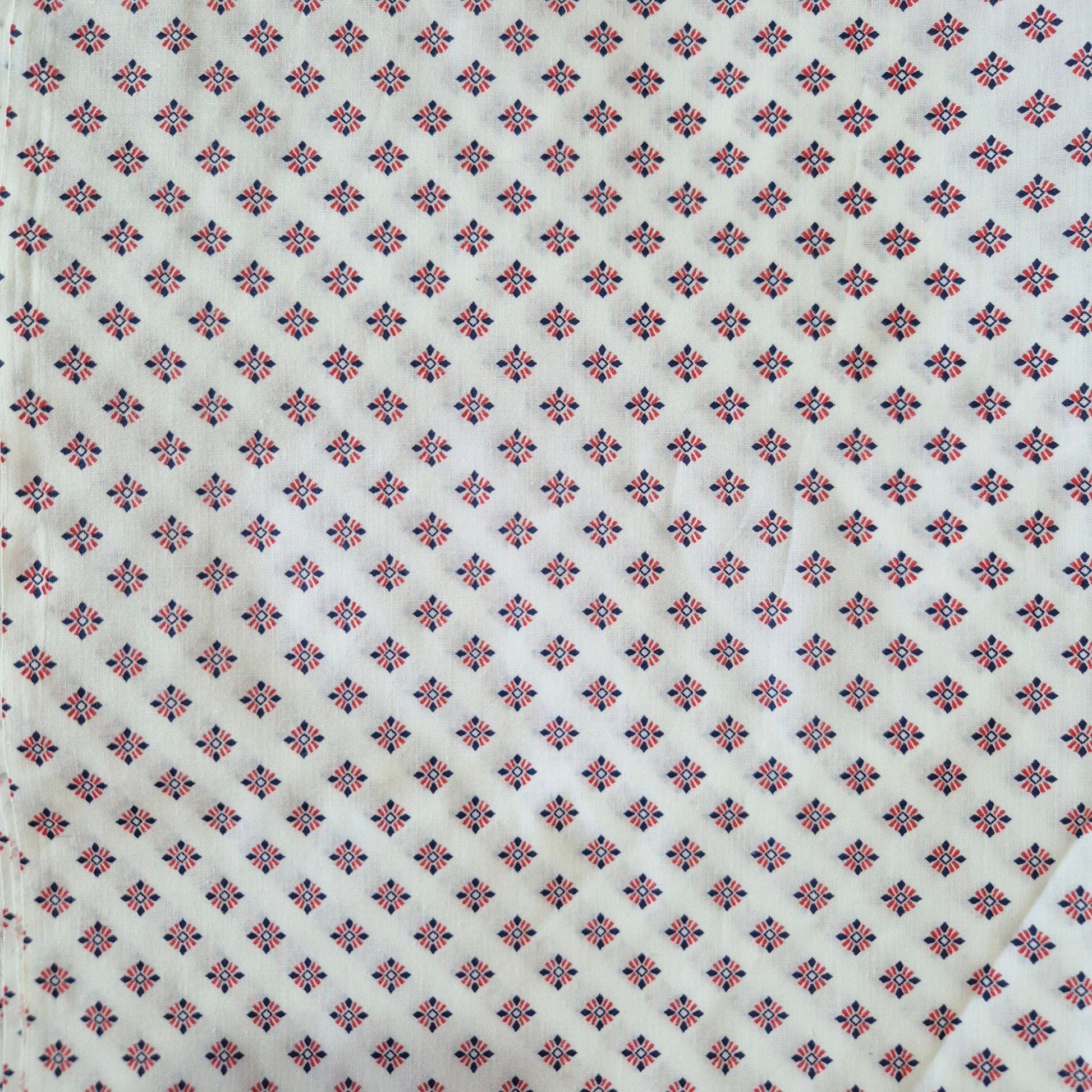 Patterned fabric with small geometric design on a white background