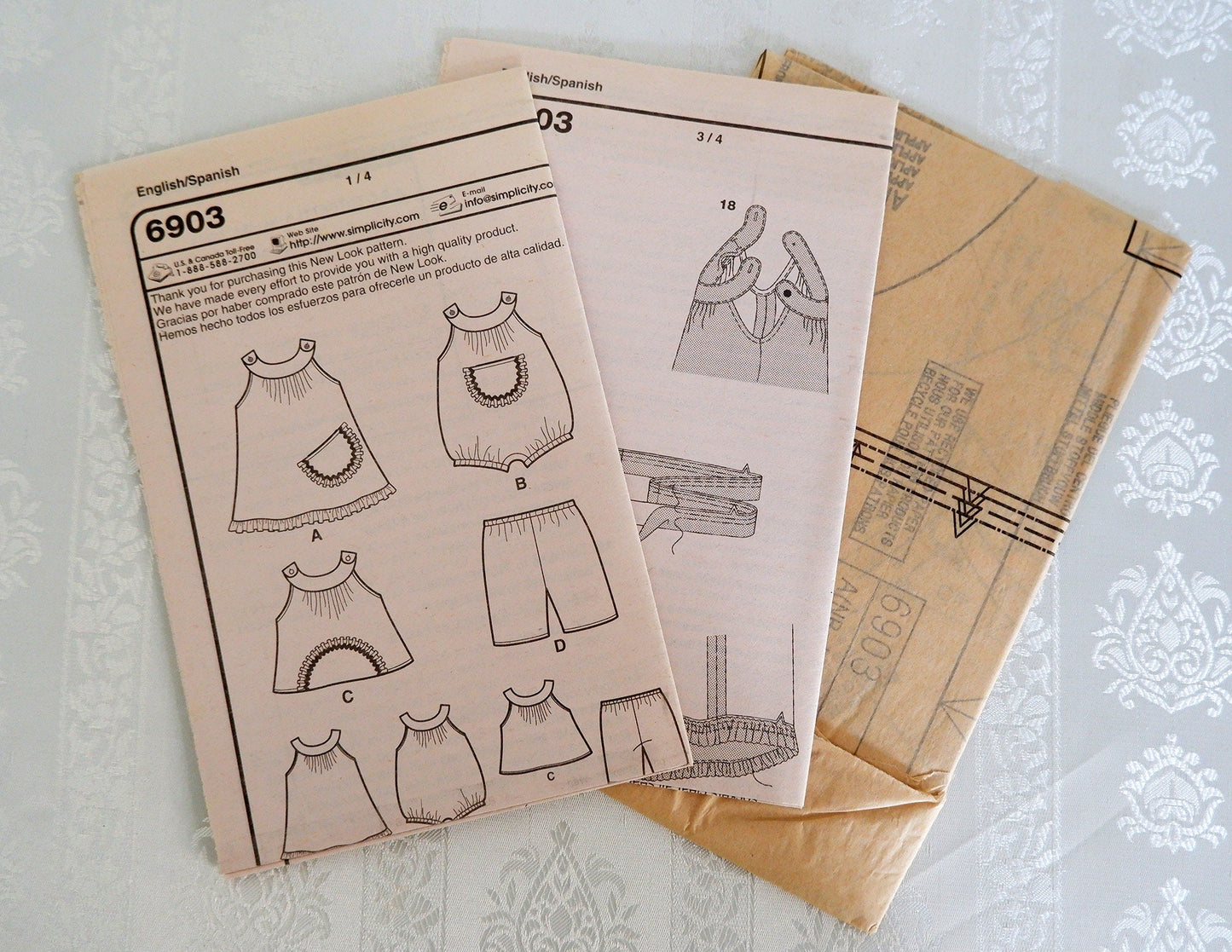 Sizes newborn - large, babies dress romper top and pants pattern, New Look 6903